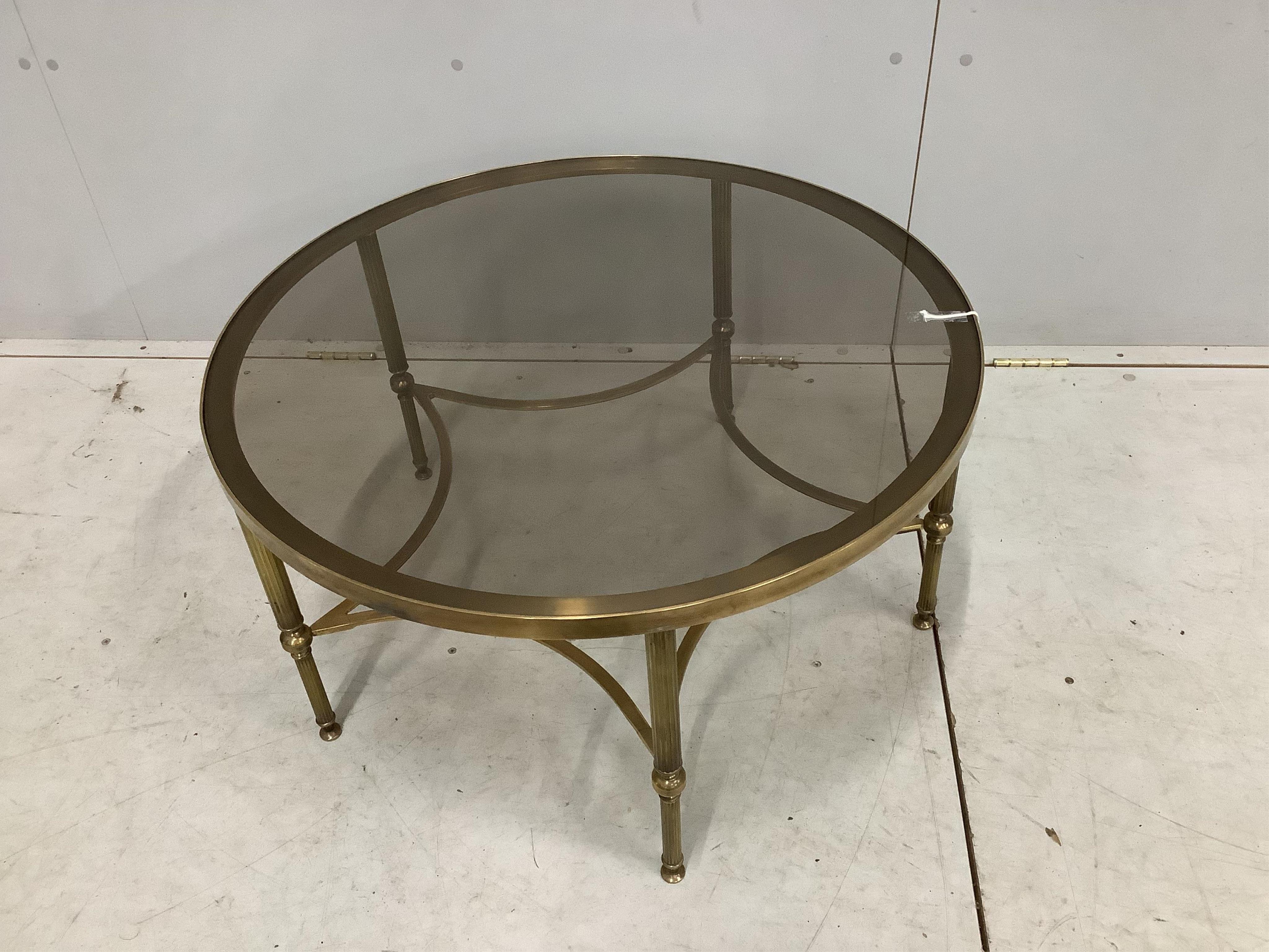 A Maison Jansen style circular brass glass top coffee table. Diameter 77cm, height 41cm, Condition - good